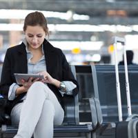 Woman using tablet at airport