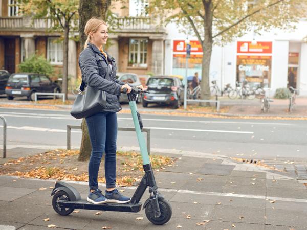 Woman riding electric scooter