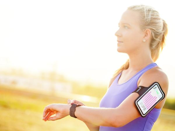 Woman using fitness tracker smartwatch