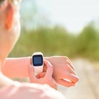 Woman running with fitness tracker