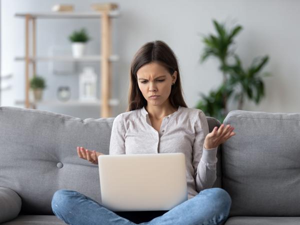 Frustrated woman with laptop, no wifi