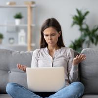 Frustrated woman with laptop, no wifi