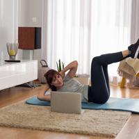 Woman doing online workout at home