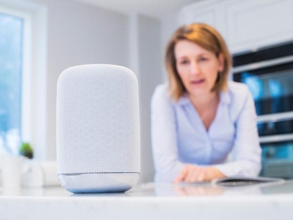 Woman using smart speaker