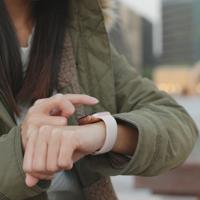 Woman using smartwatch outdoors